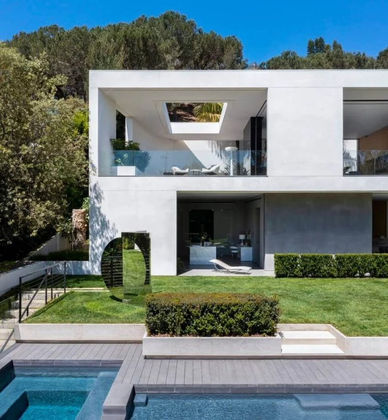 White two-storey villa beside a swimming pool