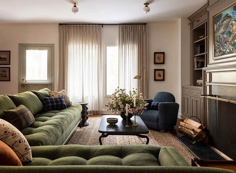 Residential living room with green sofas, an armchair and a coffee table arranged as a seating group.